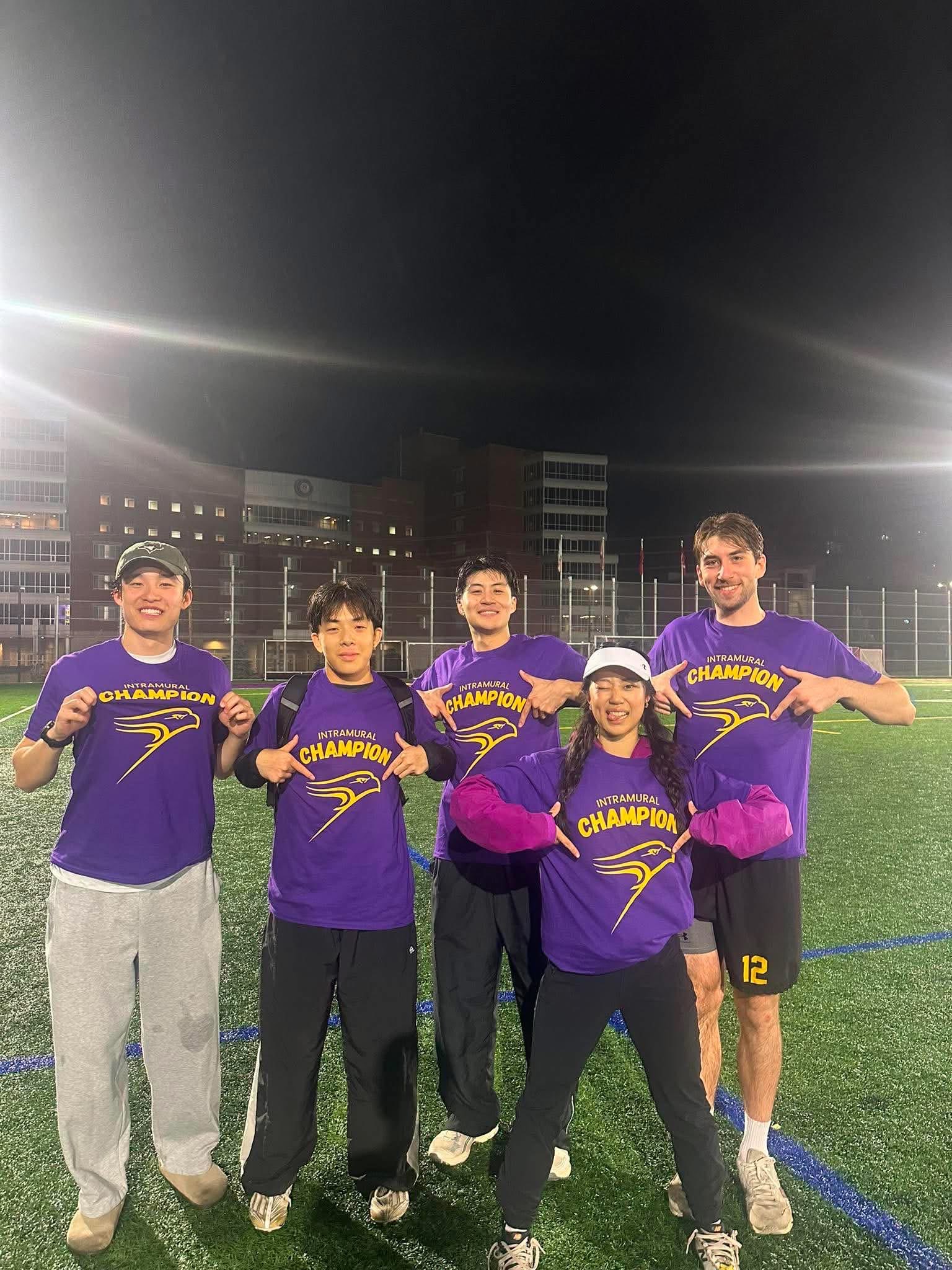 Five of us in purple Intramural Champion shirts under the field lights